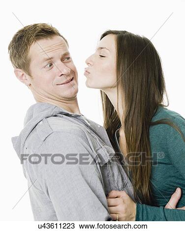 Stock Image - Studio shot of young couple. Fotosearch