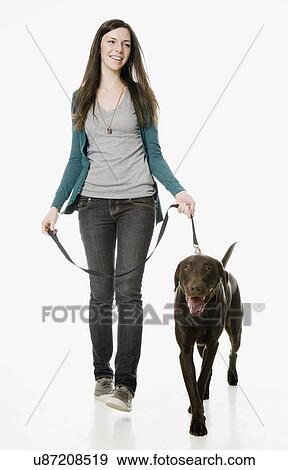 Studio shot of young woman with chocolate labrador View Large Photo Image Stock Photo - Studio shot of young woman with chocolate labrador. Fotosearch