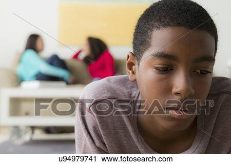 Teenage boy (14-15) crying while two friends(12-13, 16-17) whispering behind her View Large Photo Image Stock Image - Teenage boy (14-15) crying while two friends(12-13, 16-17) whispering behind her. Fotosearch