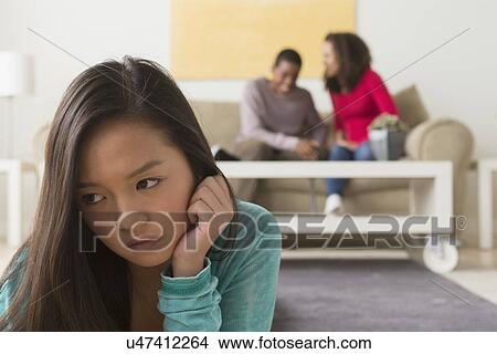 Teenage girl (16-17) crying while two friends (12-13, 14-15) whispering behind her View Large Photo Image Picture - Teenage girl (16-17) crying while two friends (12-13, 14-15) whispering behind her. Fotosearch