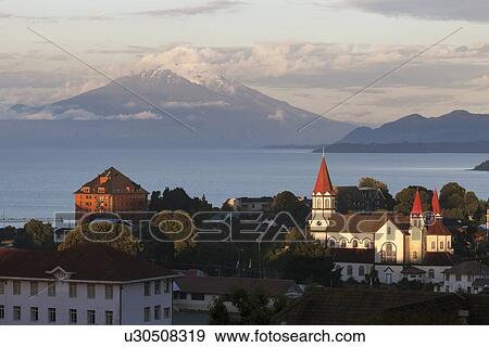 Stock Photo - Town skyline with volcano in background. Fotosearch