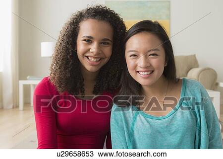 Two friends (12-13, 16-17) sitting on sofa View Large Photo Image Stock Image - Two friends (12-13, 16-17) sitting on sofa. Fotosearch