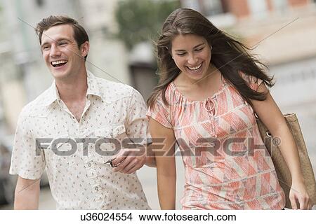 Urban couple laughing View Large Photo Image Picture - Urban couple laughing. Fotosearch