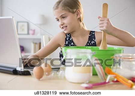 View of girl (8-9) baking View Large Photo Image Stock Photo - View of girl (8-9) baking. Fotosearch