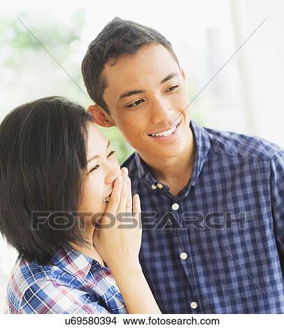 View of young couple smiling View Large Photo Image Picture - View of young couple smiling. Fotosearch