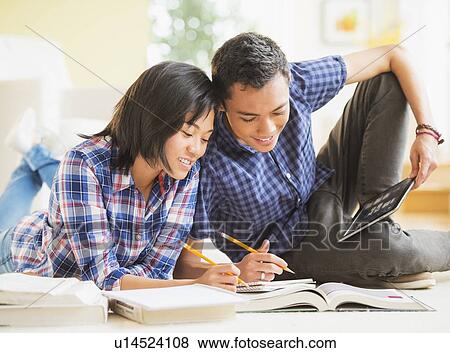 Stock Photo - View of young woman and young man learning. Fotosearch