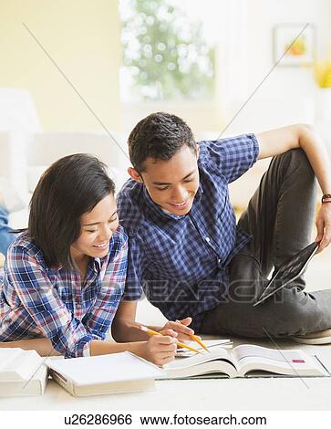 Stock Photograph - View of young woman and young man learning. Fotosearch