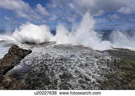 Stock Photo - Wave crushing on rock. Fotosearch