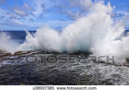 Stock Photography - Wave crushing on rock. Fotosearch