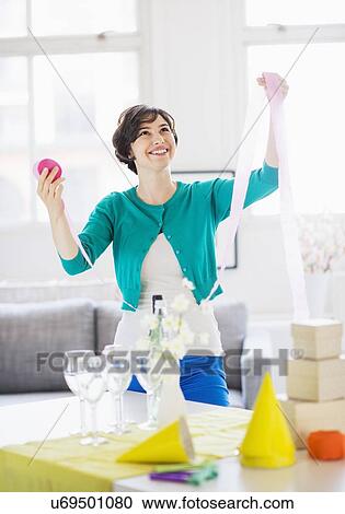 Woman decorating room for party View Large Photo Image Stock Image - Woman decorating room for party. Fotosearch
