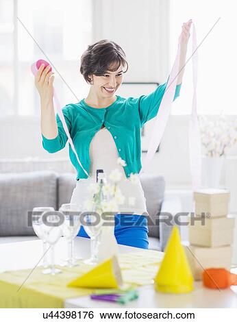 Woman decorating room for party View Large Photo Image Stock Photograph - Woman decorating room for party. Fotosearch