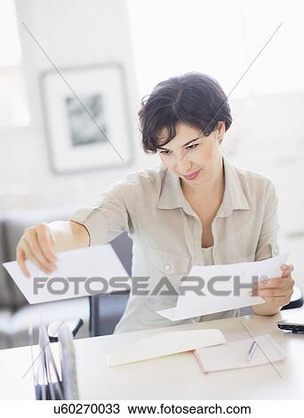 Woman doing paperwork at home office View Large Photo Image Stock Image - Woman doing paperwork at home office. Fotosearch