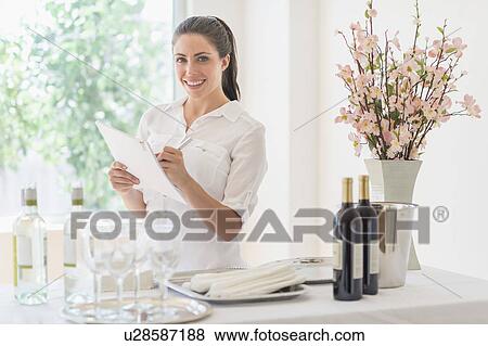 Woman preparing table in restaurant View Large Photo Image Stock Photo - Woman preparing table in restaurant. Fotosearch