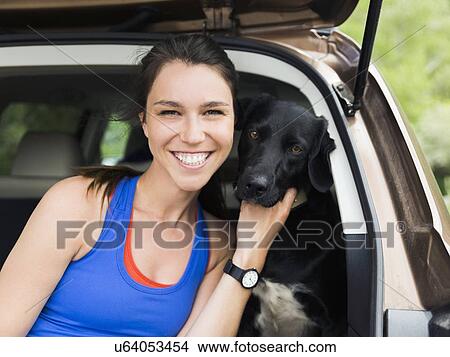 Woman sitting in car with dog View Large Photo Image Picture - Woman sitting in car with dog. Fotosearch