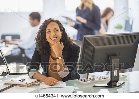 Woman smiling in office View Large Photo Image Stock Image - Woman smiling in office. Fotosearch