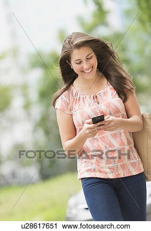 Stock Image - Woman texting on phone. Fotosearch