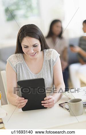 Woman using digital tablet View Large Photo Image Stock Image - Woman using digital tablet. Fotosearch