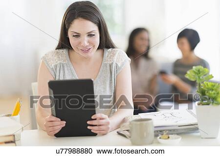 Woman using digital tablet View Large Photo Image Stock Image - Woman using digital tablet. Fotosearch