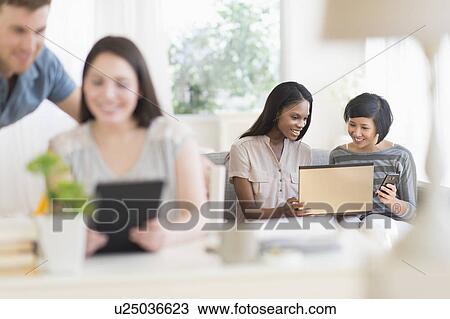 Women and man using laptop and digital tablet View Large Photo Image Stock Image - Women and man using laptop and digital tablet. Fotosearch