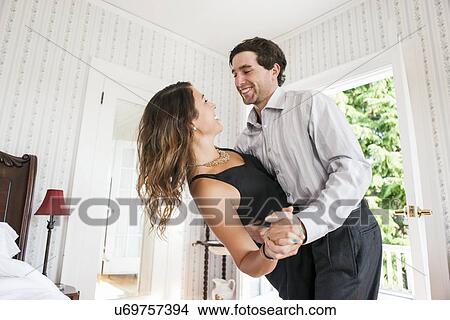 Young couple dancing in bedroom View Large Photo Image Picture - Young couple dancing in bedroom . Fotosearch