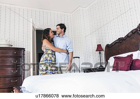 Young couple embracing in hotel room View Large Photo Image Stock Photo - Young couple embracing in hotel room. Fotosearch