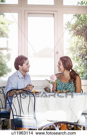 Young couple enjoying meal View Large Photo Image Picture - Young couple enjoying meal. Fotosearch