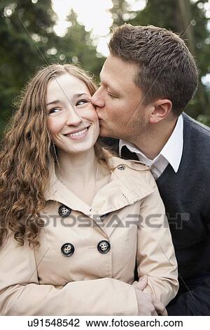 Young couple kissing View Large Photo Image Stock Image - Young couple kissing. Fotosearch