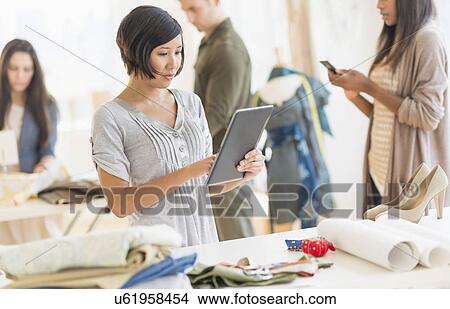 Picture - Young fashion designers working in studio. Fotosearch