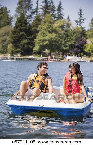 Young man and woman on paddle boat View Large Photo Image Stock Photography - Young man and woman on paddle boat. Fotosearch