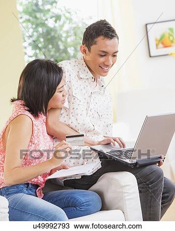 Young people doing online shopping together View Large Photo Image Stock Image - Young people doing online shopping together. Fotosearch