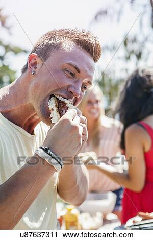 Young people enjoying barbecue View Large Photo Image Stock Image - Young people enjoying barbecue. Fotosearch
