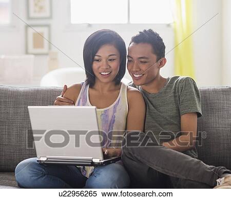 Young woman and young man using laptop View Large Photo Image Stock Photography - Young woman and young man using laptop. Fotosearch