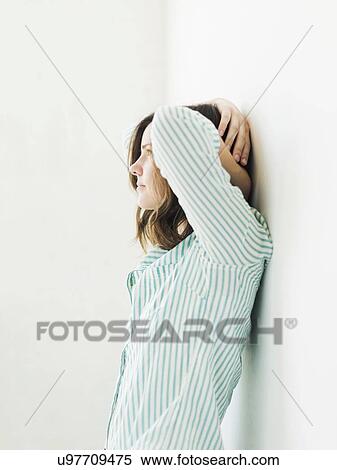 Young woman leaning on wall View Large Photo Image Stock Photography - Young woman leaning on wall. Fotosearch