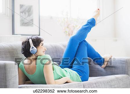 Young woman listening to music at home View Large Photo Image Stock Image - Young woman listening to music at home. Fotosearch