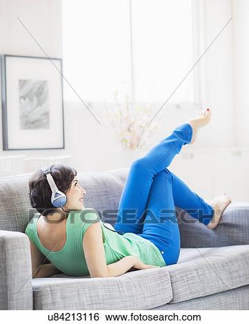 Young woman listening to music at home View Large Photo Image Stock Photograph - Young woman listening to music at home. Fotosearch