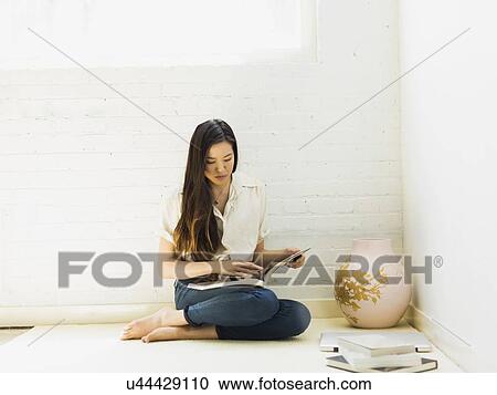 Stock Image - Young woman reading. Fotosearch