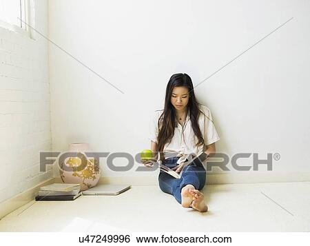 Stock Photograph - Young woman reading. Fotosearch