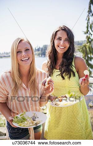 Young women enjoying barbecue View Large Photo Image Picture - Young women enjoying barbecue. Fotosearch