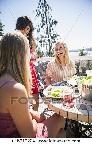 Young women enjoying outdoor meal View Large Photo Image Picture - Young women enjoying outdoor meal. Fotosearch