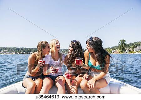 Young women having fun on motorboat View Large Photo Image Stock Photo - Young women having fun on motorboat. Fotosearch