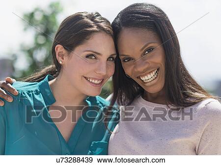 Stock Photo - Young women smiling. Fotosearch