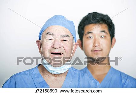 A portrait of Senior adult surgeon and a young Asian doctor View Large Photo Image Stock Image - A portrait of Senior adult surgeon and a young Asian doctor. Fotosearch