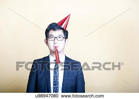 Asian business man wearing party hat View Large Photo Image Stock Image - Asian business man wearing party hat. Fotosearch