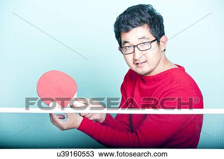 Asian man playing table tennis View Large Photo Image Stock Image - Asian man playing table tennis . Fotosearch