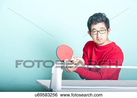 Asian man playing table tennis View Large Photo Image Stock Photograph - Asian man playing table tennis . Fotosearch