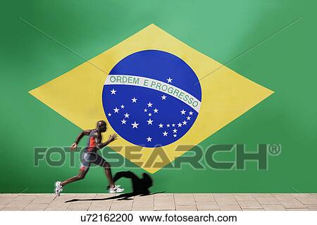 Athlete running past Brazilian flag View Large Photo Image Stock Image - Athlete running past Brazilian flag. Fotosearch