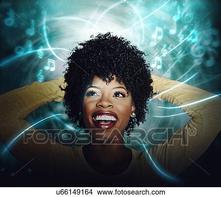 Beautiful African American Young woman listening to online streaming music View Large Photo Image Picture - Beautiful African American Young woman listening to online streaming music. Fotosearch