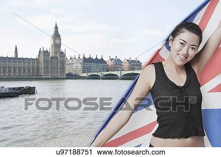 Stock Image - Beautiful Asian girl standing in front of Big Ben and Houses of Parliament. Fotosearch