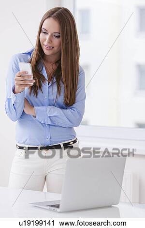 Beautiful businesswoman using cell phone View Large Photo Image Stock Image - Beautiful businesswoman using cell phone . Fotosearch