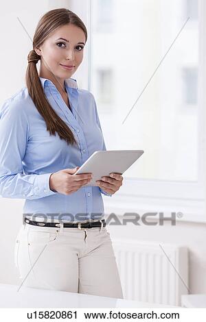 Stock Image - Beautiful businesswoman using tablet computer . Fotosearch